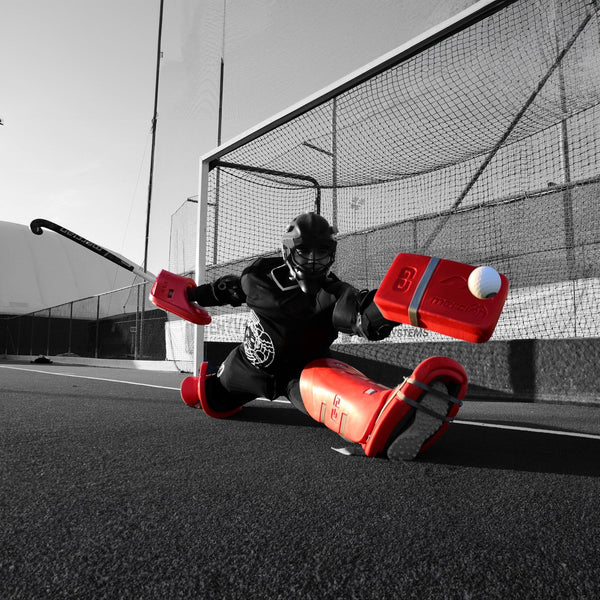 Mercian Athlete Doing the Splits to Save the Ball, Wearing Mercian Legguards, Kickers, Stick and Glove