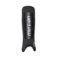 Mercian SGEV26BLK black hockey shin guards front view featuring integrated ankle sleeve, durable hard-shell shin protection and bold Mercian branding for secure all-game performance.